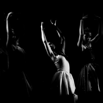 group of dancers with arms raised