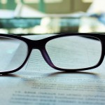 image of glasses resting on a book