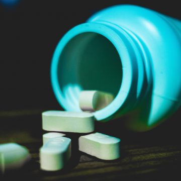 pills spilling out of pill bottle, decorative image