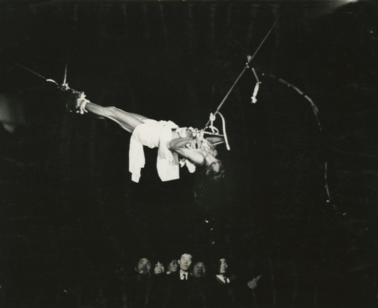 image: Hijikata lifted above the crowd at the culmination of the performance.
