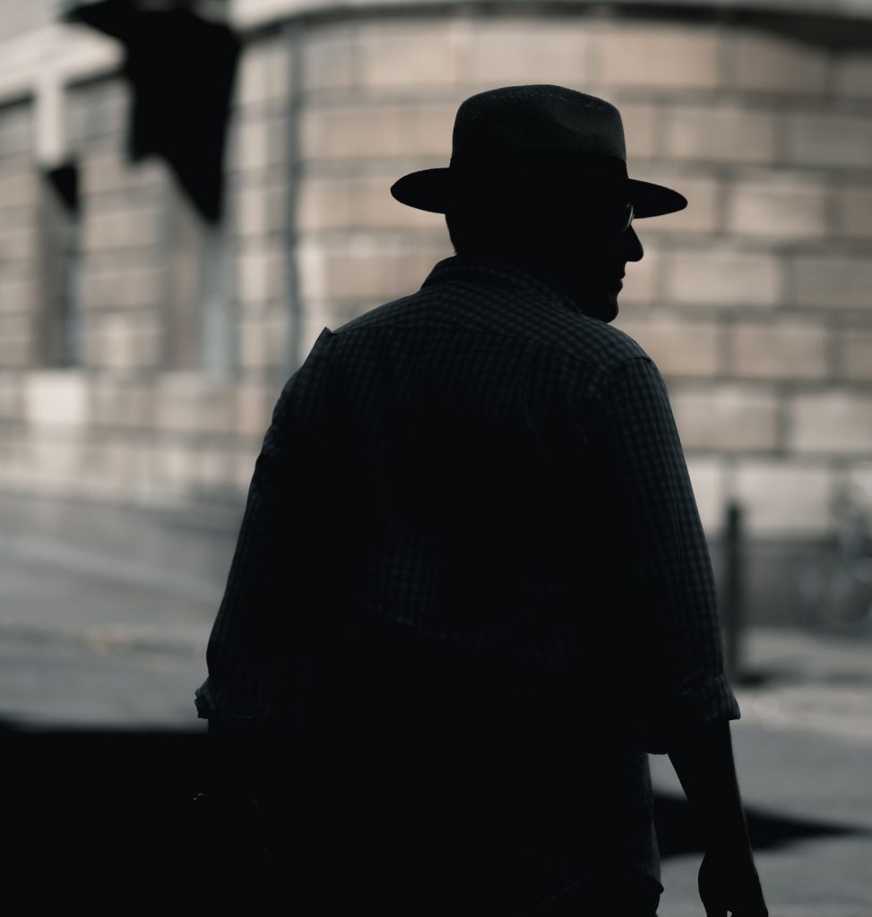 deco image: man with hat in shadow