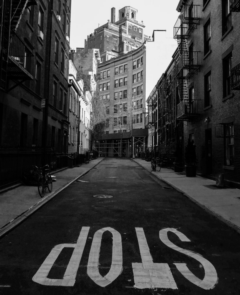 deco image: city streets with STOP painted on road