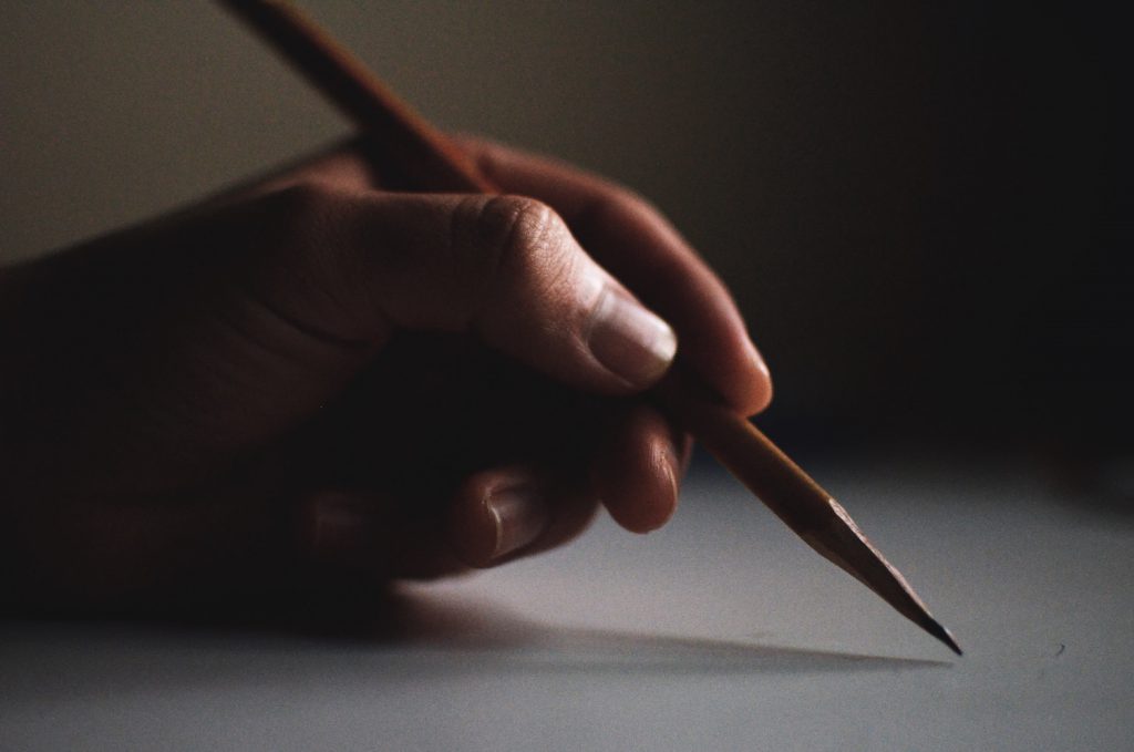 deco image: pencil in hand
