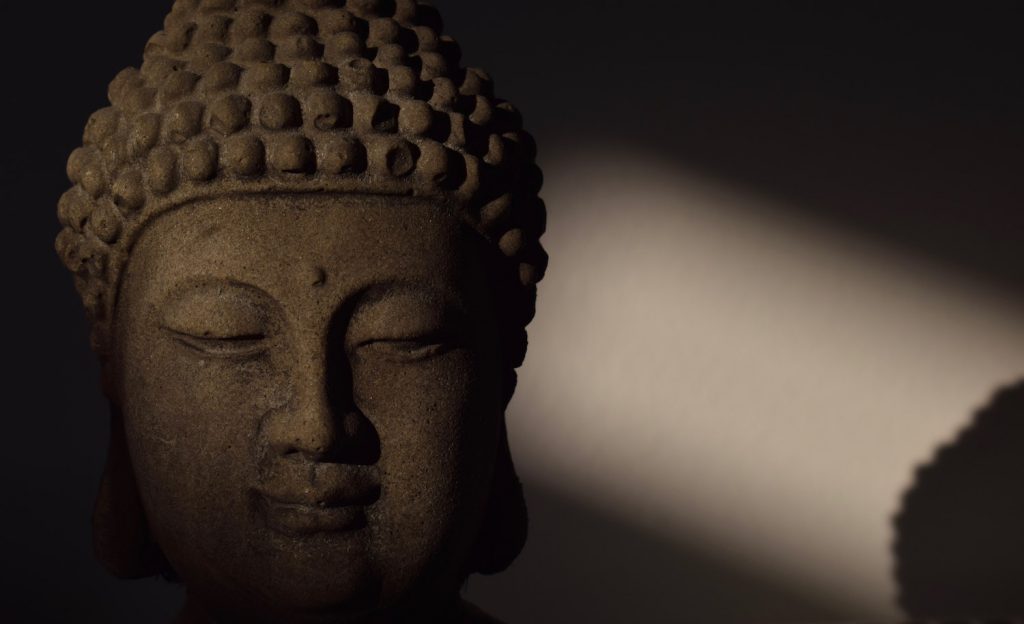 decorative image: Buddha head statue